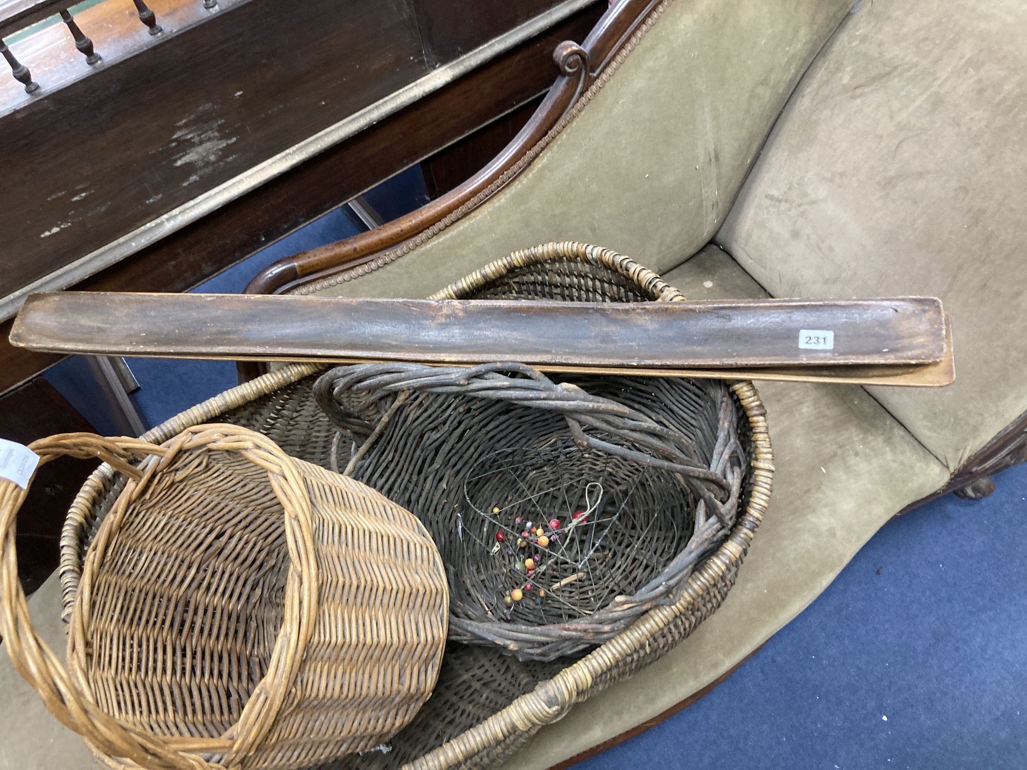 Three wicker baskets, a wirework basket and two baguette stands